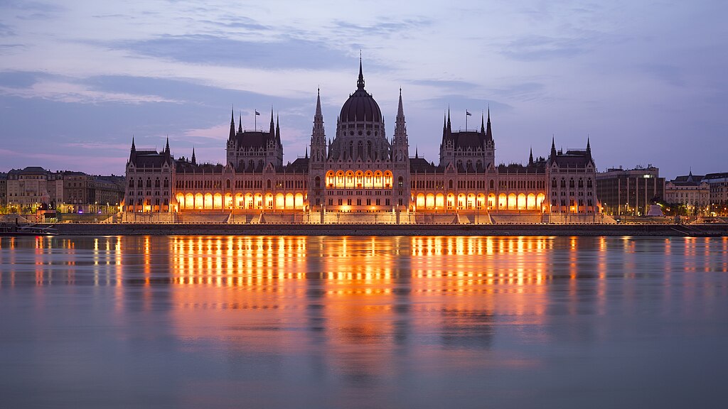 Stunning Hungarian Parliament Building reflecting on the Danube at sunset